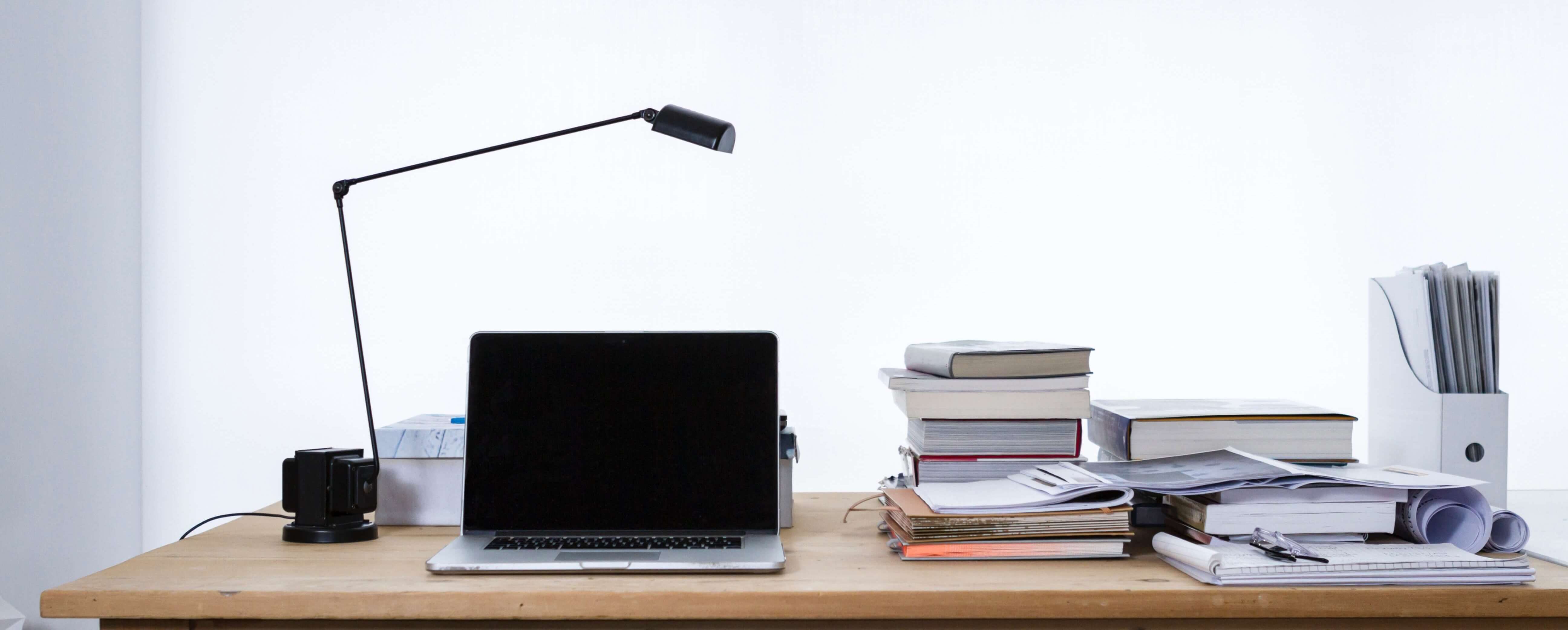 laptop and books on a desk