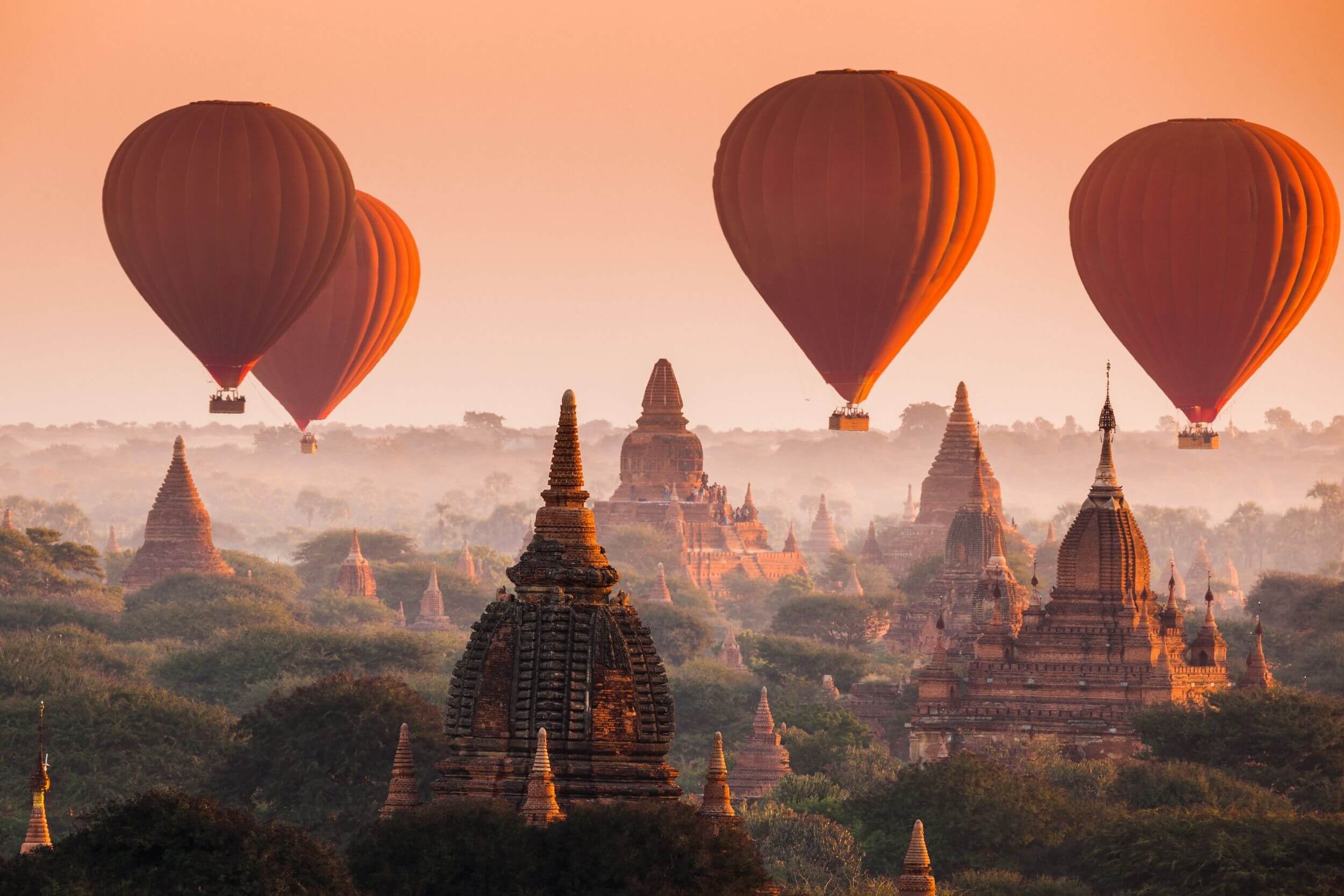 Bagan, Myanmar with hot air balloons floating overhead